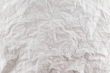 Background from crumpled white paper close-up. Pleated paper