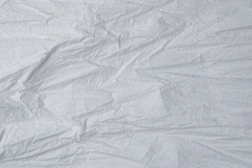 Crumpled white paper background.