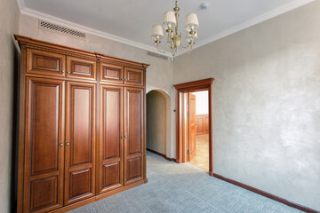 Large wooden cabinet in an empty room