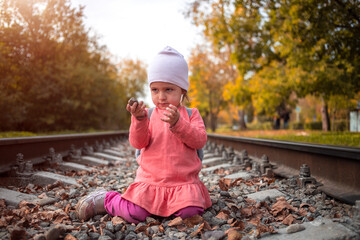 toddler girl on railroad alone autumn day