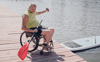 Person with a physical disability who uses wheelchair will be ride on sup board