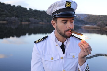 Ship captain lighting a cigar
