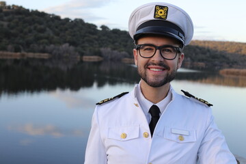 Ship captain with elegant uniform wearing eyeglasses - obrazy, fototapety, plakaty