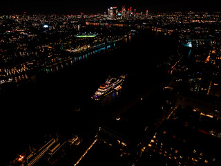 Stunning panorama view over Thames river to The financial district Canary Wharf in London during night. Aerial drone view