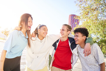 Multiracial group of young students laughing and hugging. People having fun and friendship concept.
