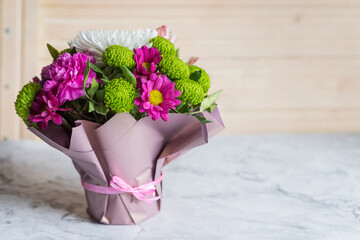 Bouquet of varied flowers.bouquet of colorful chrysanthemums, roses and gypsophila. traditional gift for a woman, a teacher.composition on stone background for wedding, ceremony, different occasions