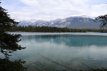 Beautiful blue clear lake Anette in Jasper. Wonderful road trip through Banff and Jasper national park in British Columbia, Canada. An amazing day in Vancouver. What a beautiful nature in Canada.