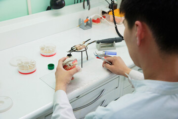 Dental technician doing partial dentures of acrylic resins in the lab.