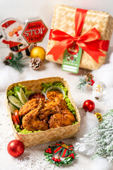 Fototapeta na wymiar A set of 'Ayam Penyet' for christmas hampers. Ayam penyet is Indonesian cuisine decorated with christmas props.