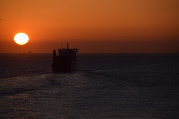 Bright sunset over ships at sea