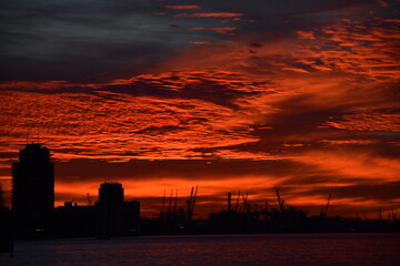 Deep red sky over silhouetted cityscape