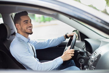 Excited arab guy going to office, driving his car