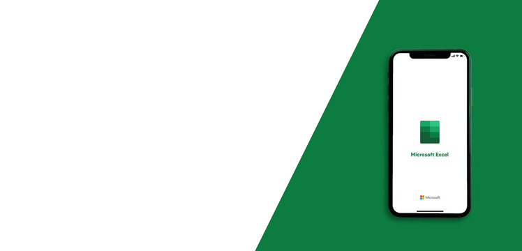 Microsoft Excel application on the smartphone screen on green background. Copy space. Top view : Chiang Mai, Thailand, 1 January 2022