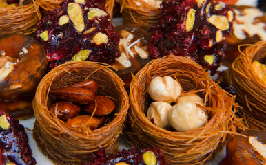 Dried fruits baklava and Turkish delight with pistachios and nuts, close-up view .