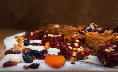 Dried fruits baklava and Turkish delight with pistachios and nuts, close-up view .