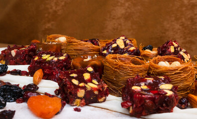 Dried fruits baklava and Turkish delight with pistachios and nuts, close-up view .