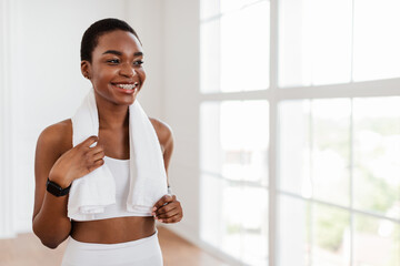 Fototapeta na wymiar Portrait of sporty black woman in white sportswear posing