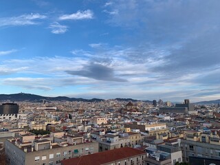 View of Barcelona city skyline from a rooftop. Sagrada de Familia and other famous sightseeing objects in the background. Aerial, panoramic, scenic view of Barcelona. Catalonia, Spain