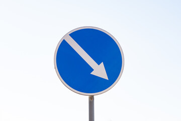 Blue arrow sign pointing the way