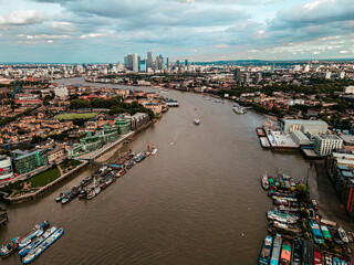 Fototapeta na wymiar Aerial view of Bank and Canary Wharf, central London's leading financial districts with famous skyscrapers at golden hour sunset with river Thames in foreground