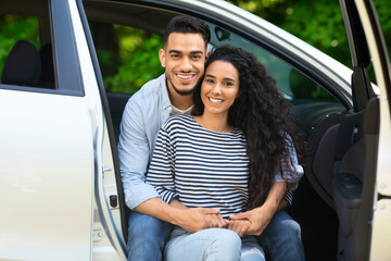 Beautiful middle-eastern lovers enjoying car trip to countryside