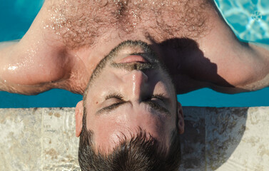 Serene man relaxing and meditating in the water pool. Tranquility concept. Life balance concept.