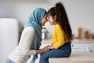 Mother's Day Concept. Adorable Little Girl Bonding With Muslim Mom In Hijab - obrazy, fototapety, plakaty