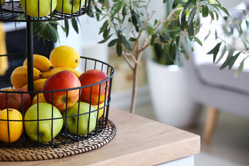 Stand with healthy fruits on counter in modern kitchen, closeup