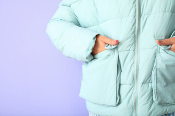Pretty young woman in stylish warm clothes on color background, closeup