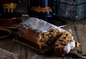 Stollen with marzipan on a rustic wooden table