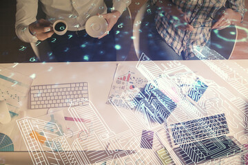 Double exposure of man and woman working together and the buildings hologram drawing. Computer background. Top View. Smart city concept.