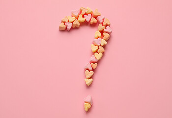 Question mark made of marshmallows on pink background