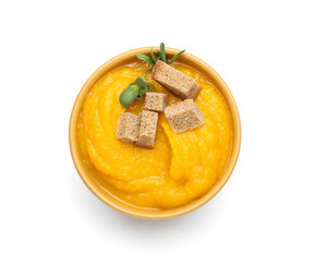 Bowl of tasty pumpkin cream soup on white background