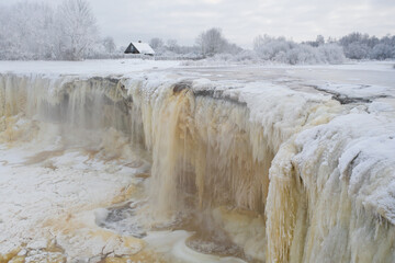 Aerial view of beautiful frozen Jagala (Estonian - Jägala) river on a cloudy winter morning. Estonia.