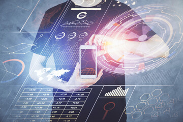 Double exposure of man's hand holding and using a digital device and data theme hologram drawing. Technology concept.