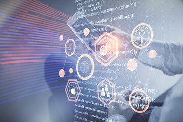 Double exposure of man's hand holding and using a digital device and data theme drawing. Technology concept.
