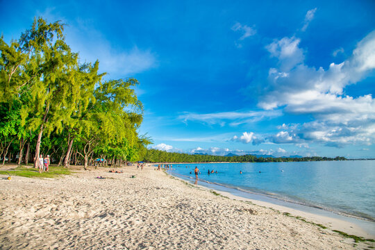 MAURITIUS - APRIL 24, 2019: Tourists And Locals Along A Famous Beach.