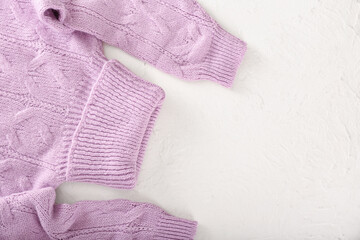 Knitted roll-neck sweater on light background