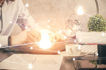 Double exposure of man's hands holding and using a phone and social network theme drawing.