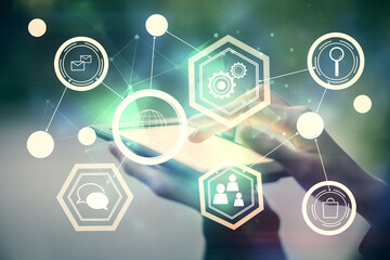 Double exposure of social network sketch hologram and woman holding and using a mobile device.