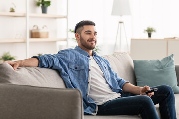Happy jewish guy spending weekend watching tv