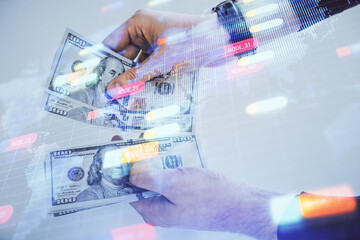 Multi exposure of technology drawing hologram and us dollars bills and man hands. Data concept