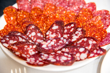 Large group of thinly sliced sausages on a plate