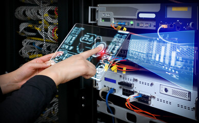 Woman holding AR device panel and analyzing system in server room. A virtual screen is floating in the air.