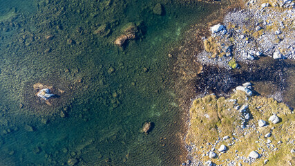 Drone photo of a mountain lake and beach in Norway