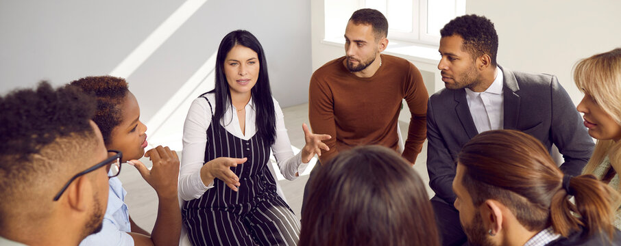 Narrow banner of diverse multiracial businesspeople in circle talk brainstorm over company business ideas together. Multiethnic employees speak engaged in team discussion. Teamwork concept.