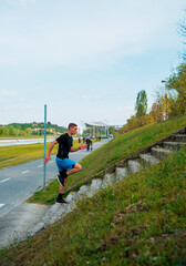 View of runner athlete running on stairs. Man fitness is jogging oudoors