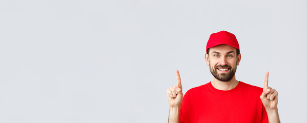 Online shopping, delivery during quarantine and takeaway concept. Cheerful bearded smiling courier...