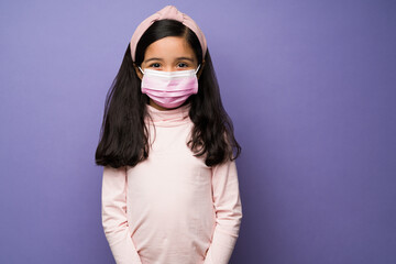 Safe kid using a face mask to prevent covid