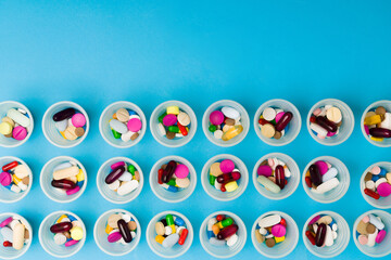 Pattern of cups with pills and tablets